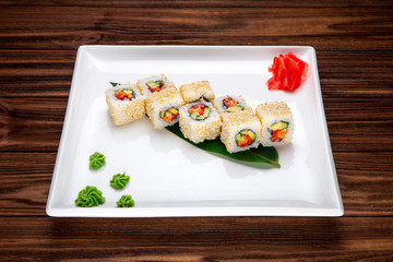 Delicious Sushi rolls served on a wooden plate