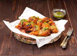 Grilled chicken legs with spicy green sauce.