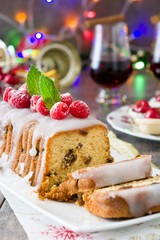 Christmas fruit cake and Christmas decoration on a rustic wooden table

