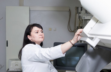 Brunette female doctor working with x-ray machine