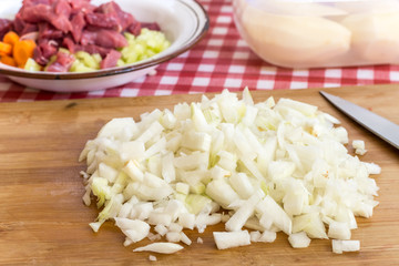 Chopped onions on the kitchen wooden board