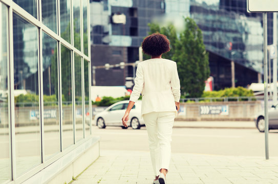 african american businesswoman walking in city