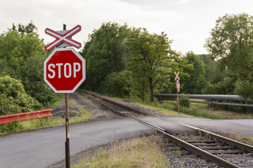 Stop sign traffic and railroad crossing.