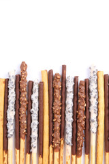 Assorted chocolate dipped biscuit sticks on white background