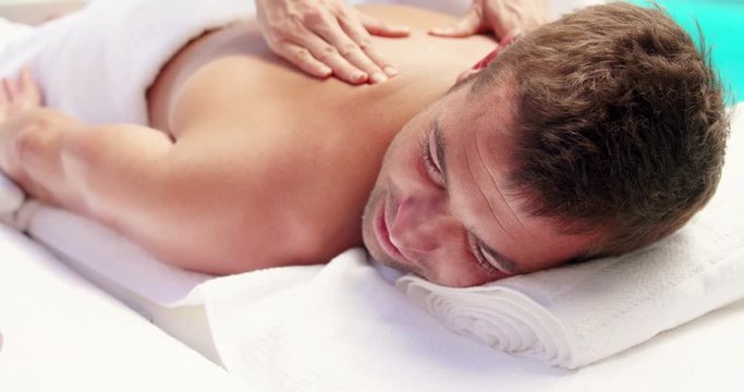 Man receiving a back massage in slow motion 