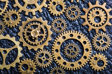 steampunk mechanical cogs gears wheels on leather background