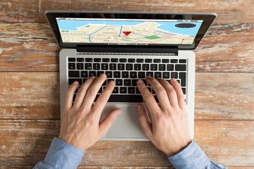 close up of male hands with laptop typing