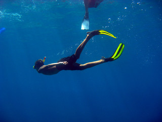 Diver swimming with snorkel in the sea