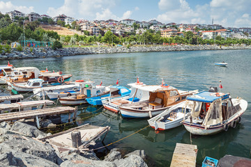 Fototapeta na wymiar Old wooden fishing boats moored in small port