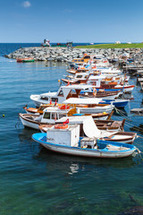 Obraz premium Vertical photo of colorful wooden fishing boats