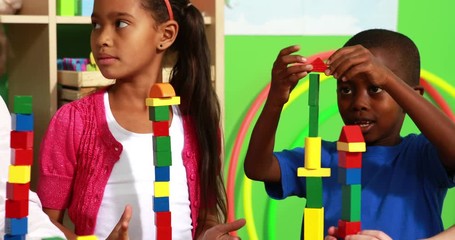 Cute classmates playing with building blocks