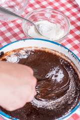 Mixing flour with melted chocolate cream