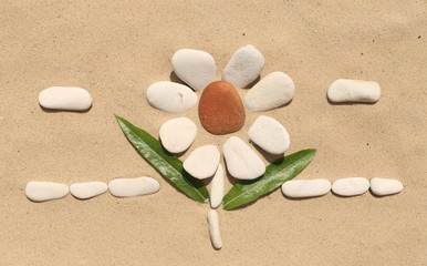 flower stone, lying on the sand. made of white pebbles and red. for designers and print