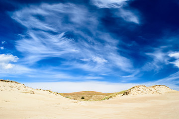 Spectacular cloudy sky over sandy ground