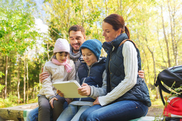 Fototapeta premium happy family with tablet pc and backpacks at camp