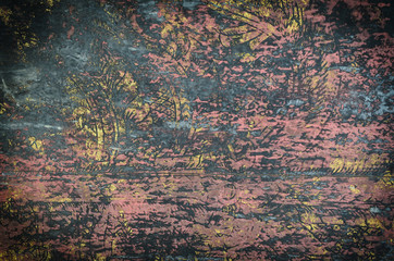 Old gold ornament on wooden wall..