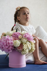 little girl with a big bouquet of fresh flowers