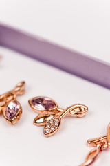 Macro image of golden earrings with diamond stones