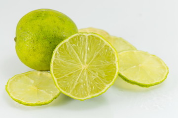 Lime fruit sliced and placed on white table