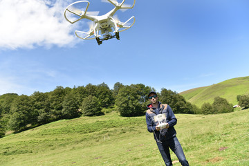 Man handling drone in nature