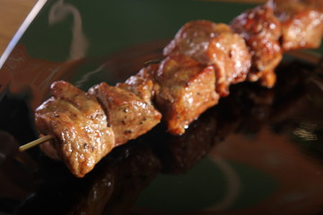 skewer on a black plate