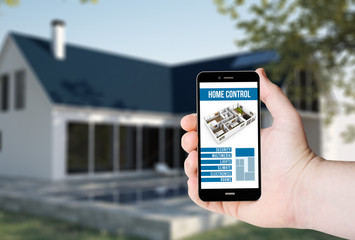 Hand hold a phone with Remote home control system on a screen