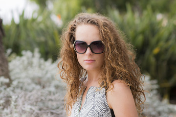 Woman portrait close-up. Beautiful girl in sunglasses smiling. 