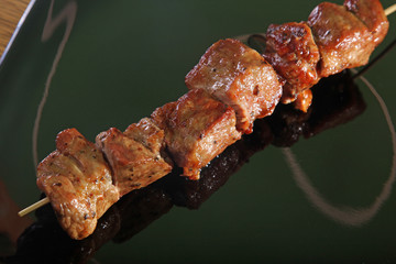 skewer on a black plate