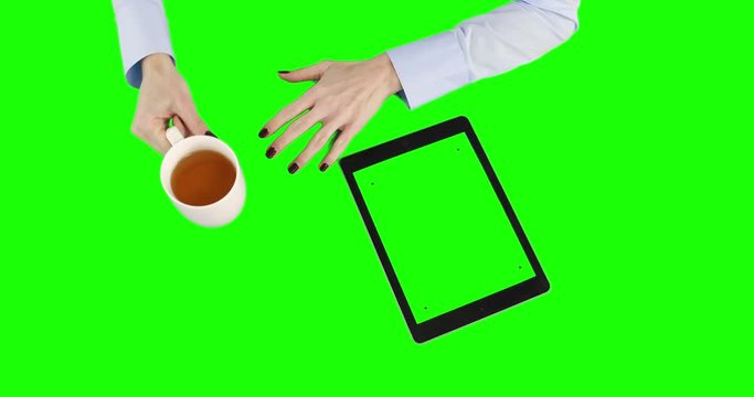 Businesswoman drinking coffee and waiting on green screen