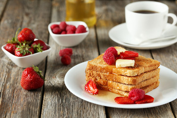 Fresh toast with raspberry and strawberry on grey wooden backgro