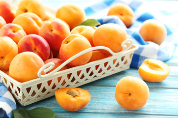 Ripe apricots fruit on blue wooden table