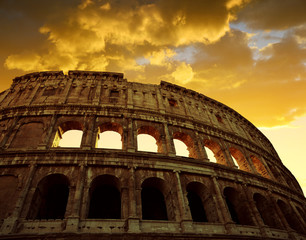 Colosseum in Rome with sunset sky in the background, Italy