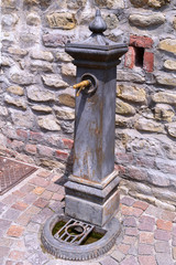 Fototapeta na wymiar An old metal fountain