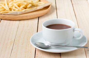 chocolate coffee in white glass and snack food on wood