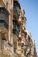 Fototapeta na wymiar Street with Traditional maltese balconies