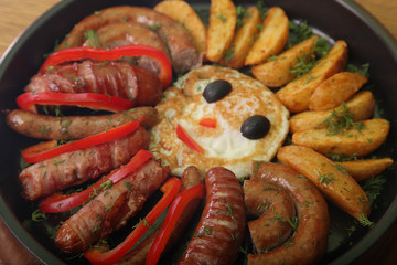 sausage and peppers with potatoes in a pan