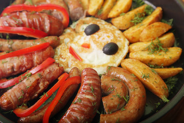 sausage and peppers with potatoes in a pan