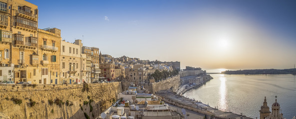 Valletta, Malta - Panoramic skyline view of the ancient walls and houses of Valletta at sunrise