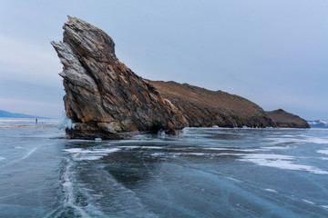 The man is looking at the Cape Ogoy. Baikal, Russia.