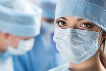 Close-up portrait of young female surgeon doctor