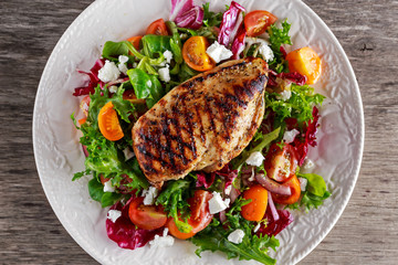 Grilled Chicken Breast fillet with fresh tomatoes vegetables salad. concept healthy food.