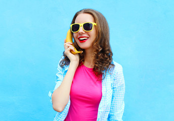 Portrait pretty cool smiling woman with banana having fun over c