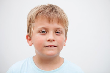 Funny blond boy looking at camera