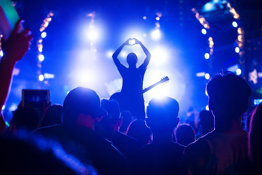 Singer singing on concert stage with ray of illuminated, Singer and guitar on stage