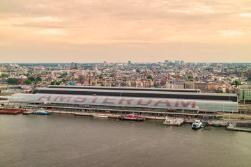 Fotobehang Aerial view of Amsterdam with the central station in front © Martin Bergsma