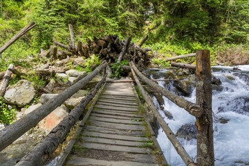 Wooden bridge over mountain stream