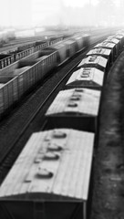 Vertical black and white toy train echelon bokeh background