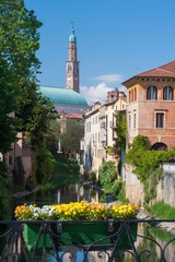 Obraz premium Flowered balcony of Monte Furo in Vicenza, Italy, with a view of retrone river and the clock tower in the distance
