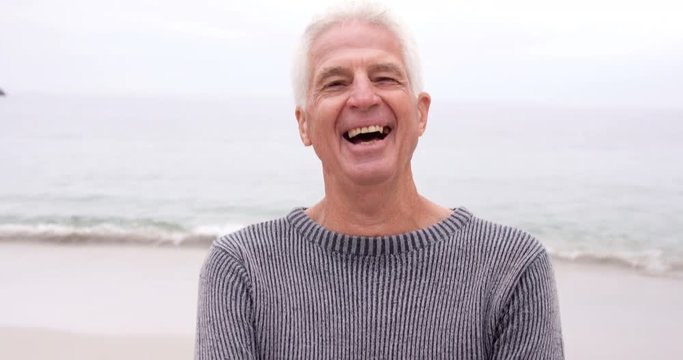 Happy retired man on holidays at the beach