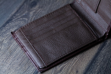 brown leather wallet on wood board background